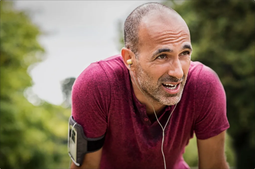 Runner Sweating - Middle Aged Man Wearing a Purple Shirt